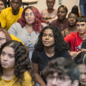A group of students sit listening to a lecture