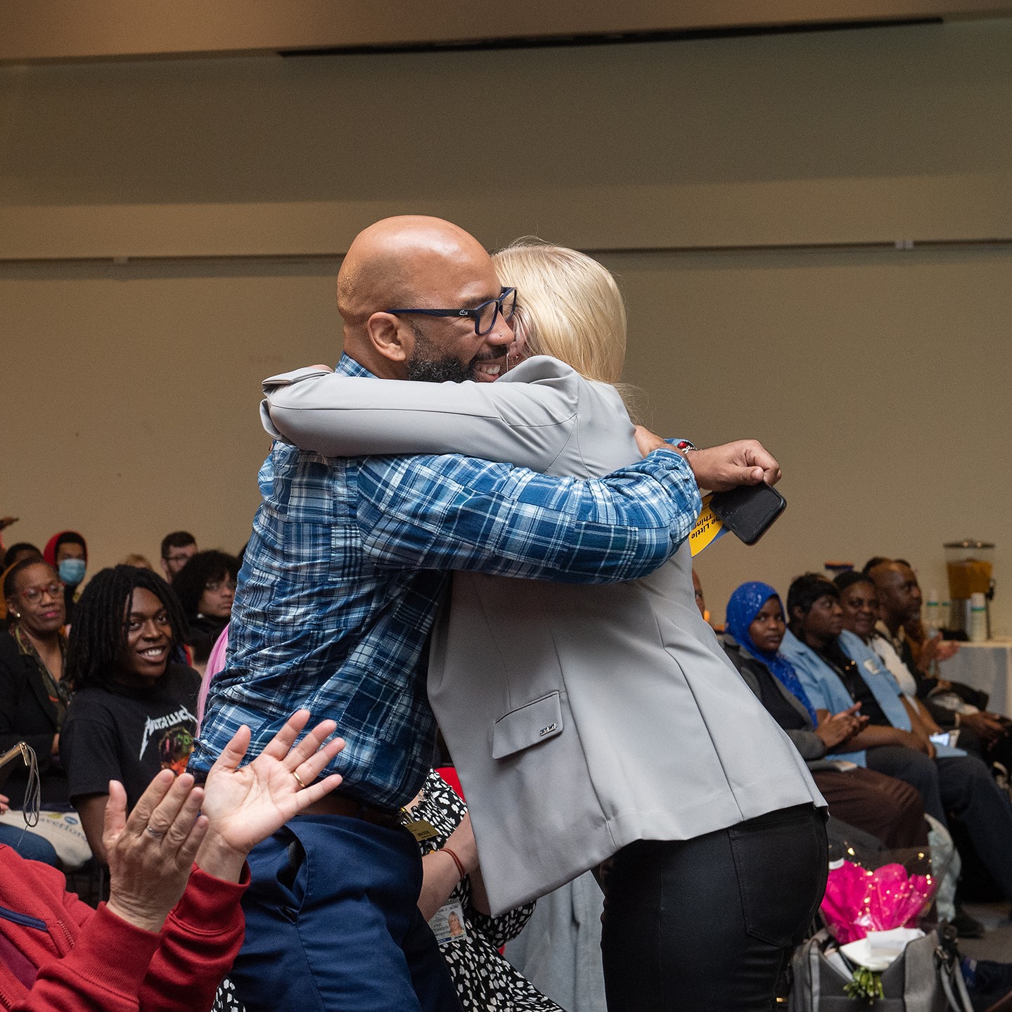 Two people hug during a ceremony